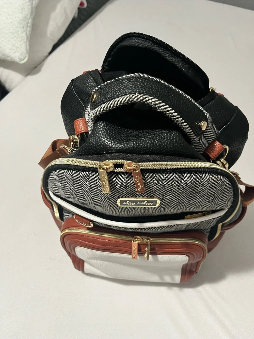 Itzy Ritzy Baby Diaper Bag Backpack in Black, White, brown with wipes case
